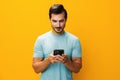 Man smiling smartphone yellow portrait phone cyberspace communication studio happy phone copy mobile space Royalty Free Stock Photo