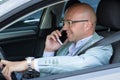 Man smiling talking on mobile phone while driving his car Royalty Free Stock Photo