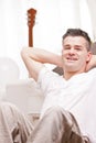 Man smiling to camera relaxing in his living room Royalty Free Stock Photo