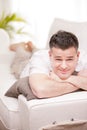 Man smiling to camera relaxing in his living room Royalty Free Stock Photo
