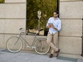 Man smiling using internet with digital tablet pad on vintage cool retro bike