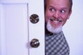 Man sneaking into house from doorway. Royalty Free Stock Photo