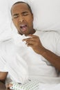 Man Sneezing In Bed Royalty Free Stock Photo