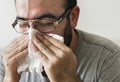 Man sneezing into tissue paper Royalty Free Stock Photo