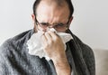 Man sneezing into tissue paper Royalty Free Stock Photo
