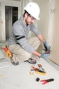 Man snipping wall wiring Royalty Free Stock Photo
