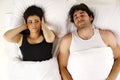 Man snoring keeping woman awake in bed Royalty Free Stock Photo