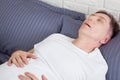 Man snoring because of sleep apnea lying in the bed Royalty Free Stock Photo