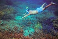 Man snorkeling in coral reef. Man dives in full face mask undersea. Snorkeling in tropical sea underwater photo Royalty Free Stock Photo