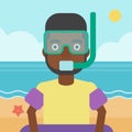 Man with snorkeling equipment on the beach.