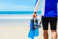 Man with snorkeling gear in hands going to sea on beach Royalty Free Stock Photo