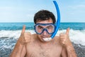 Man with snorkeling mask for diving stands near the sea Royalty Free Stock Photo