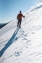 Man in snow snowshoes.