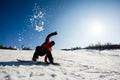 Man on a snowboard falling down on snow