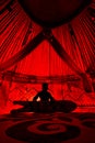 Man with snowboard inside Yurt nomadic house with red light