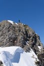 Man with snowboard on top of a mountain, extreme moutaineering. Royalty Free Stock Photo