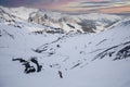 A man is snowboarding down the hill on the steep slope in Alps. High mountain area on mountains