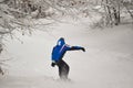Man snowboarding on fresh white snow on ski slope on winter day