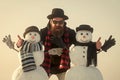 Man and snowman, winter holiday celebration outdoor. Winter leisure and winter season. Funny santa man with snowman in Royalty Free Stock Photo