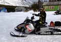 The man and snowmobile on the rescue station