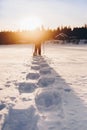 Man in snowshoes is walking with beautiful sunrise light. Outdoor winter activity Royalty Free Stock Photo