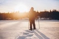 Man in snowshoes is walking with beautiful sunrise light. Outdoor winter activity Royalty Free Stock Photo