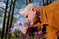 Man snuffing a flower. Royalty Free Stock Photo