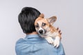 A man snuggling and hugging his dog, close friendship loving in