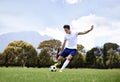 Man, soccer player and shooting with ball on field with power, speed and aim at target in training for club. Person