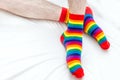 Man in socks of rainbow colors. LGBT concept. Close-up. White background