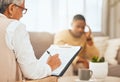 Man on sofa, therapist writing notes on clipboard for mental health advice and consulting in office. Stress, anxiety and Royalty Free Stock Photo