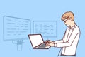Man software developer is standing at table with laptop and monitors creating server applications