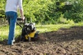 A man during soil plow process by motor cultivator perspective view Royalty Free Stock Photo