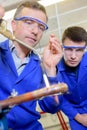 man soldering apprentice observing Royalty Free Stock Photo