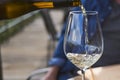 Man pouring wine into glass in a restaurant. Waiter serving drink. Wine tasting concepts