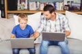 Man and son working on laptop Royalty Free Stock Photo