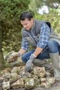 Man sorting through pile rocks Royalty Free Stock Photo