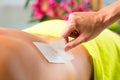 Man in Spa getting back waxed for hair removal Royalty Free Stock Photo