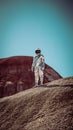 Man in a spacesuit in a wilderness Royalty Free Stock Photo