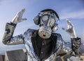 man with sparkling gas mask dancing by the sea