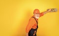 Man with spatula. process of applying layer of putty. Plastering tools for plaster. plaster trowel spatula on yellow Royalty Free Stock Photo