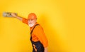 Man with spatula. process of applying layer of putty. Plastering tools for plaster. plaster trowel spatula on yellow Royalty Free Stock Photo