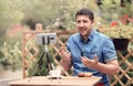 Man speaking in front of camera with attached mic lavalier. Vlogger man sitting on a table and making a vlog episode