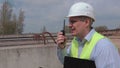 Man speaking on walky talky at construction site