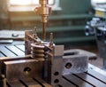 The man specialist checks the measuring tool with the size of drilling a metal pulley and inserts a drill into a Royalty Free Stock Photo