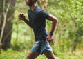 Man, speed and running in park for action, motion blur and power of cardio workout in nature. Closeup, runner and sports