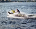 Man speeding on jet ski on lake during summer vacation