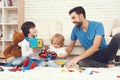 A man spends time with his sons. The father of two boys is engaged in raising children. Royalty Free Stock Photo