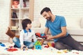 A man spends time with his sons. The father of two boys is engaged in raising children. Royalty Free Stock Photo