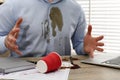 Man with spilled coffee over his workplace and shirt, closeup Royalty Free Stock Photo